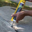 Slab Crack Application With Caulk Gun 